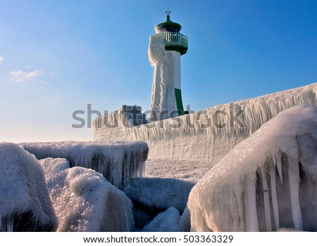 frozen Lighthouse On The Rocks