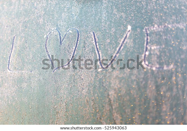 Frozen\
love on car window with heart shape on frosty windscreen as email\
or website header background symbol of\
romance