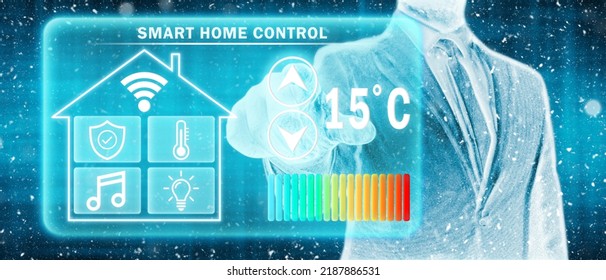 Frozen Man Adjusting Heating Temperature On A Virtual Screen Of Smart Home Controller, Winter Blizzard. Concept Of Forced Thrift, Energy War And Increased Price For Natural Gas For Heating Home.