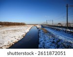 Frozen meadows with snow in the residual peat area of the Zuidplaspolder near the railroad tracks in the Netherlands