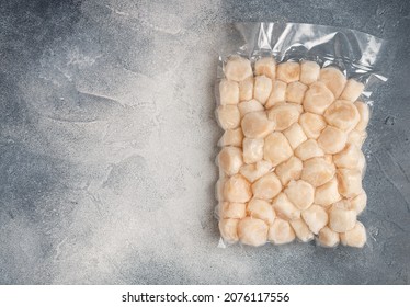 Frozen Meat Scallop In Vacuum Package. Raw Delicatessen Seafood. Concrete Or Stone Background. Selective Focus, Top View And Copy Space