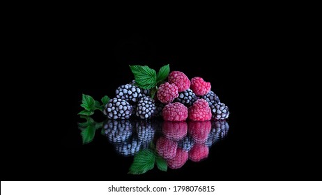 Frozen Organic Raspberry And Blackberry Berries Covered With Hoarfrost. Frozen Products. Steamy Cold Frozen Fruit. Black Background. Healthy Vegetarian Diet. Freshly From The Fridge