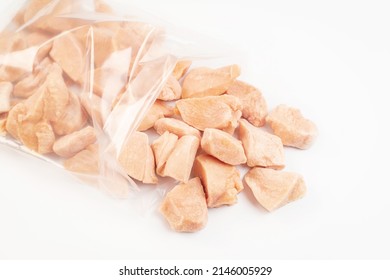 Frozen Pieces Of Chicken Fillet On An Isolated White Background.Chicken Fresh Meat In A Transparent Bag.