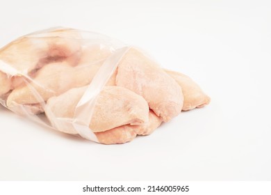 Frozen Pieces Of Chicken Fillet On An Isolated White Background.Chicken Fresh Meat In A Transparent Bag.