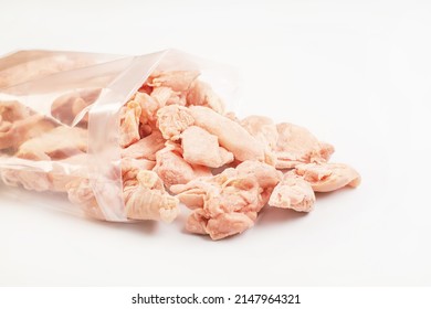 Frozen Pieces Of Chicken Fillet On An Isolated White Background.Chicken Fresh Meat In A Transparent Bag.