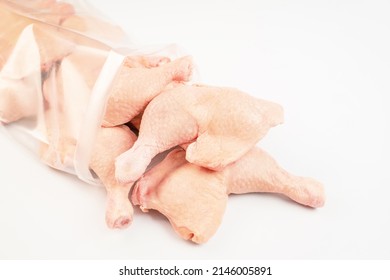 Frozen Pieces Of Chicken Leg On An Isolated White Background.Chicken Fresh Meat In A Transparent Bag.