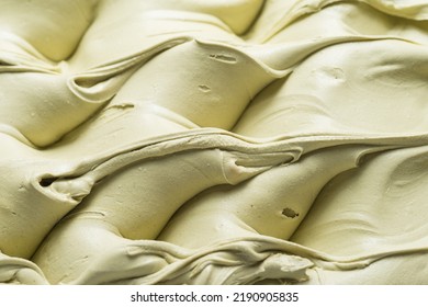 Frozen Pistachio flavour gelato - full frame detail. Close up of a creamy pastel green surface texture of Ice cream.