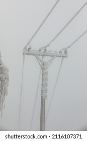 Frozen Power Line Pylons. Hoarfrost On High Voltage Cables And Pylons. Winter In The Mountains.