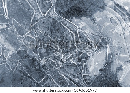 Frozen puddle with broken ice. Winter season.