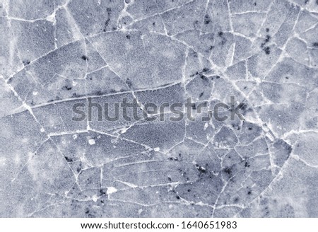 Frozen puddle with broken ice. Winter season.