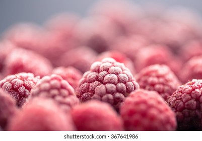 frozen raspberry on dark background