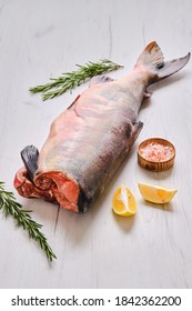 Frozen raw headless chum fish on light wooden background - Shutterstock ID 1842362200
