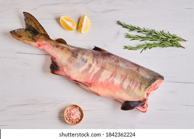 Frozen raw headless chum fish on light wooden background - Shutterstock ID 1842362224