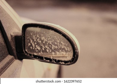 frozen rear view mirror of the car due to snowfall, view at night