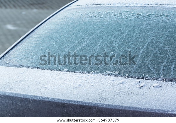 Frozen rear\
windshield in the car at\
winter