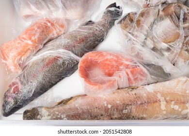 Frozen Red And White Fish Lie In A Freezer Drawer