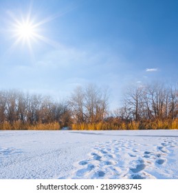 Frozen River Covered By Snow Under Sparkle Sun, Winter Outdoor Scene