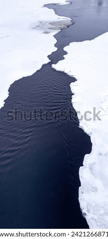 frozen river in rovaniemi finland in winter with ice and snow