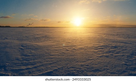 Frozen sea horizon at dawn with golden sunlight and snow-covered terrain - Powered by Shutterstock