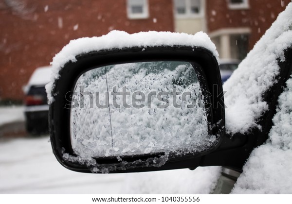 Frozen, with a snow covered front passenger\
car mirror |green |\
winter|snow