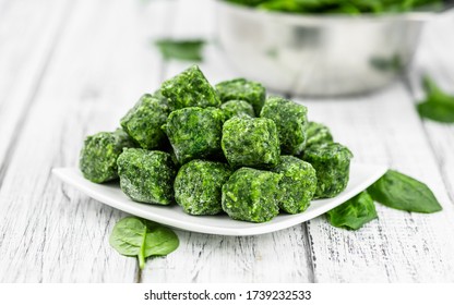 Frozen spinach cubes as detailed close up shot (selective focus)