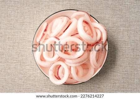 Frozen squid rings on a simple background