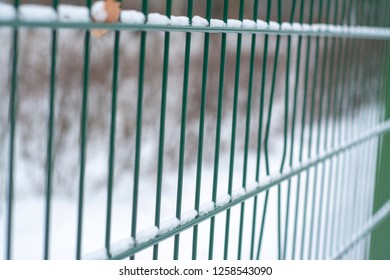 Frozen steel fence with hoarfrost