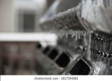 Frozen Steel Grill, Covered In Ice And Icicles, Focus On The First Grill Knob