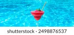 Frozen Strawberry Daiquiri at poolside on sunny summer day. Concept of cool refreshing beverages