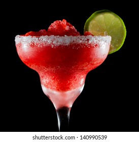 Frozen Strawberry Margarita Isolated On A Black Background Garnished With A Salt Rim And A Lime Wheel