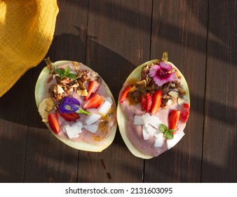 Frozen Strawberry Smoothie Served In Sun Melon Bowls Topped With Fresh Fruit, Granola And Coconut, Minimally Styled And Shot