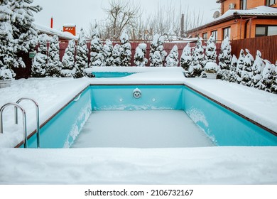 Frozen Swimming Pool Under The Snow On The Back Yard. Winter Time