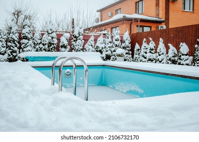 Frozen Swimming Pool Under The Snow On The Back Yard. Winter Time