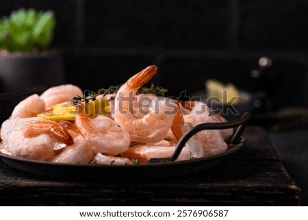 Frozen uncooked prawns or shrimps with lemon