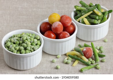 Frozen Vegetables Assorted In Bowls Isolated On White Background, Closeup, Saving Leftovers, Food Storage Concept And Eating Meals At Home Concept