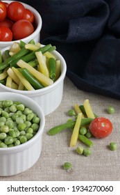 Frozen Vegetables Assorted In Bowls Isolated On White Background, Closeup, Saving Leftovers, Food Storage Concept And Eating Meals At Home Concept