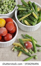 Frozen Vegetables Assorted In Bowls Isolated On White Background, Closeup, Saving Leftovers, Food Storage Concept And Eating Meals At Home Concept