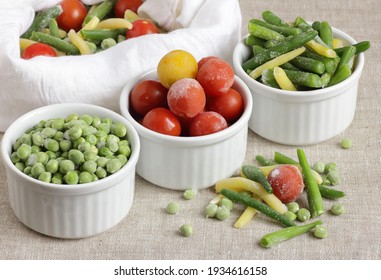 Frozen Vegetables Assorted In Bowls Isolated On White Background, Closeup, Saving Leftovers, Food Storage Concept And Eating Meals At Home Concept