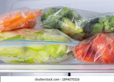 Frozen Vegetables In Bags In Freezer Close-up, Front View