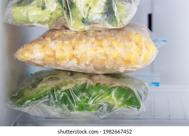 Frozen Vegetables In Bags In Freezer Close-up, Front View