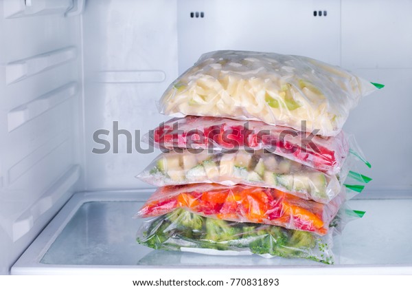 Frozen vegetables in\
bags in refrigerator