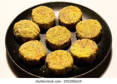 Frozen Veggie Nuggets With Lentils And Greens On A Black Plate