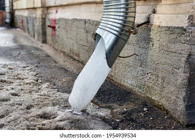 Frozen Water In A Downspout Creates Drainage Problems