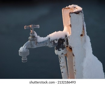 Frozen Water Faucet With Defocused Background