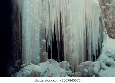 Frozen waterfall in front of cave in the cliffs in the Korouoma Canyon, shot in snow in winter in Lapland, Finland - Powered by Shutterstock