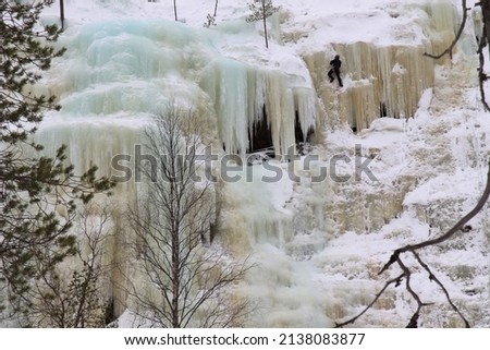 A frozen waterfall in Korouoma nature reserve in Finnish Lapland. 
The ice-climber on top of the photo looks very small. 