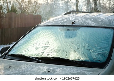 The Frozen Window Of A Car In Cold Winter Day. Frost Pattern. Selective Focus