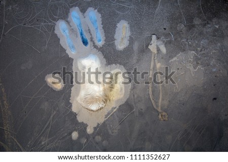 Frozen window with a hand print, background texture