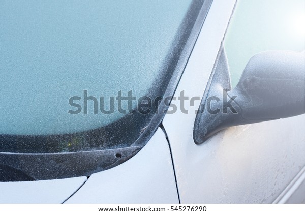 Frozen windshield\
wiper on car. Frozen windshield.   car windshield in winter. Frozen\
front window of a car. Frozen car windshield in winter.  Front\
Glass. Cold winter.