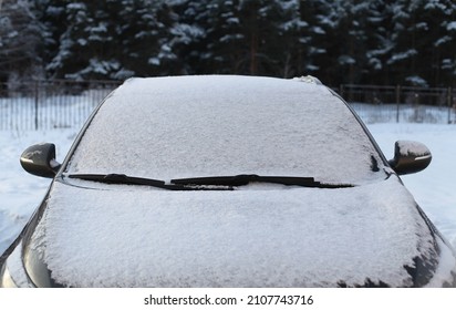 Frozen Winter Car Covered Snow, View Front Window Windshield On Snowy Forest Background